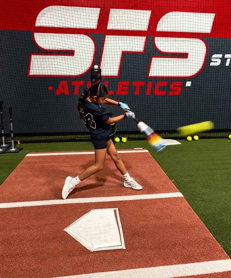 A young athlete swinging in an SFS hitting tunnel