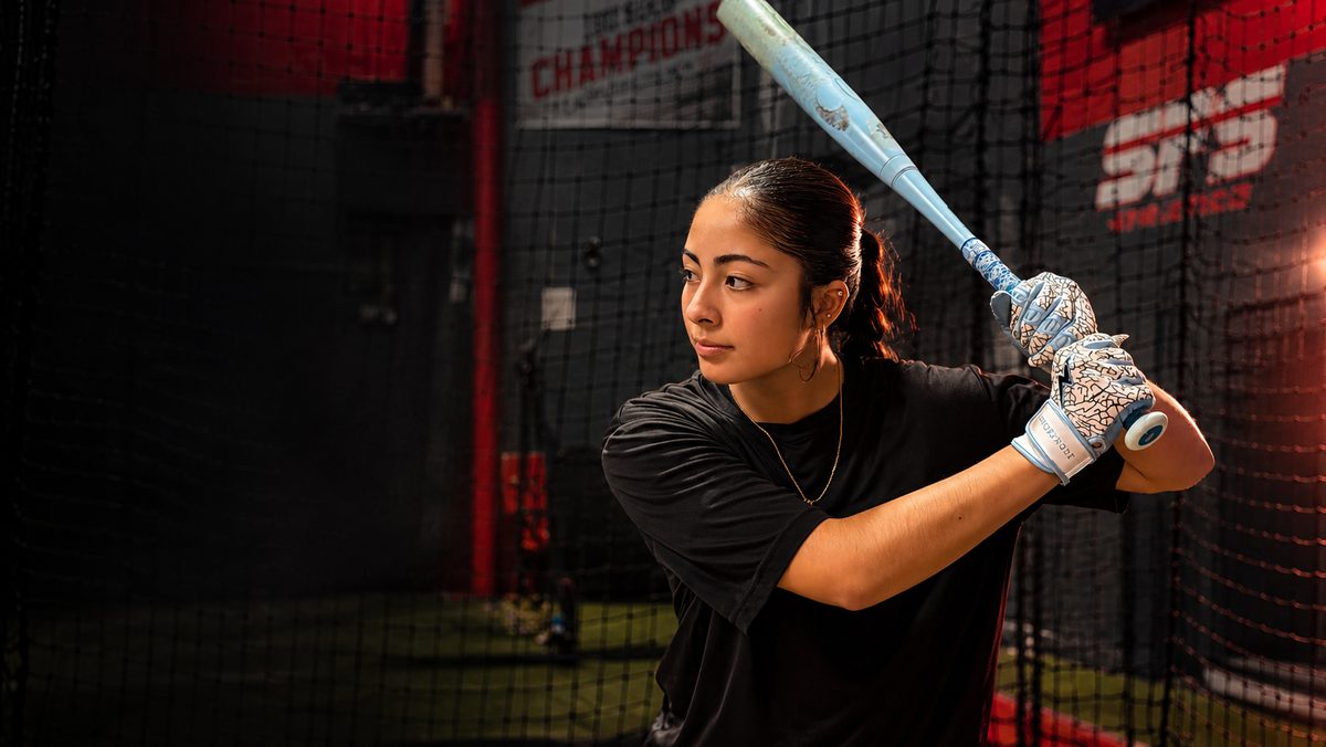 SFS softball hitter loaded and ready to swing inside the SFS batting cage